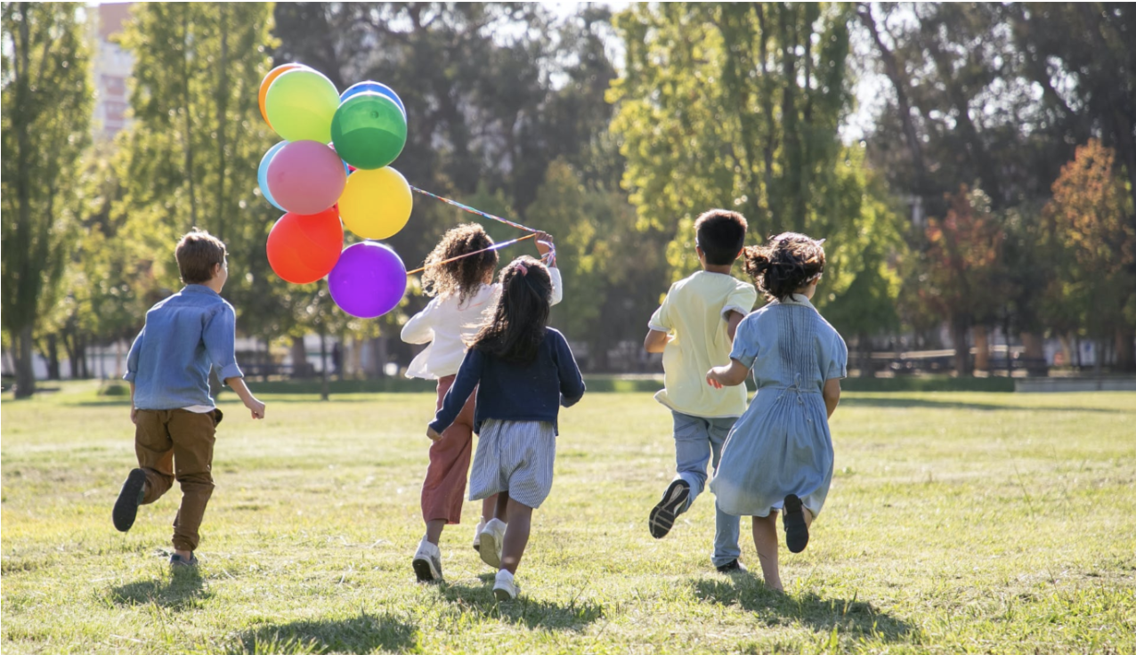 Kids playing in park with balloon