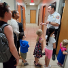 a firefighter talks to families at an open house