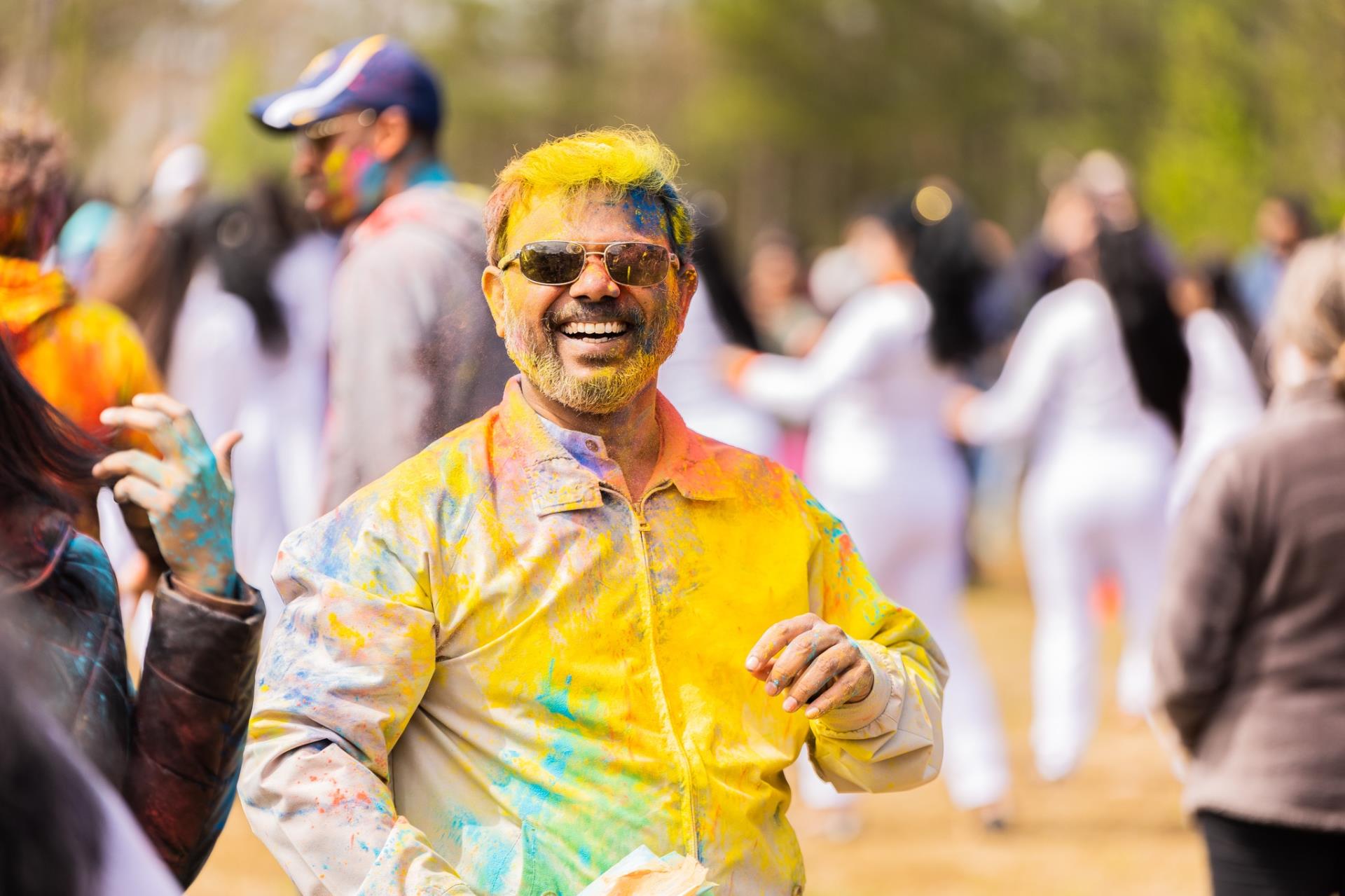 a man covered in yellow at the Holi festival