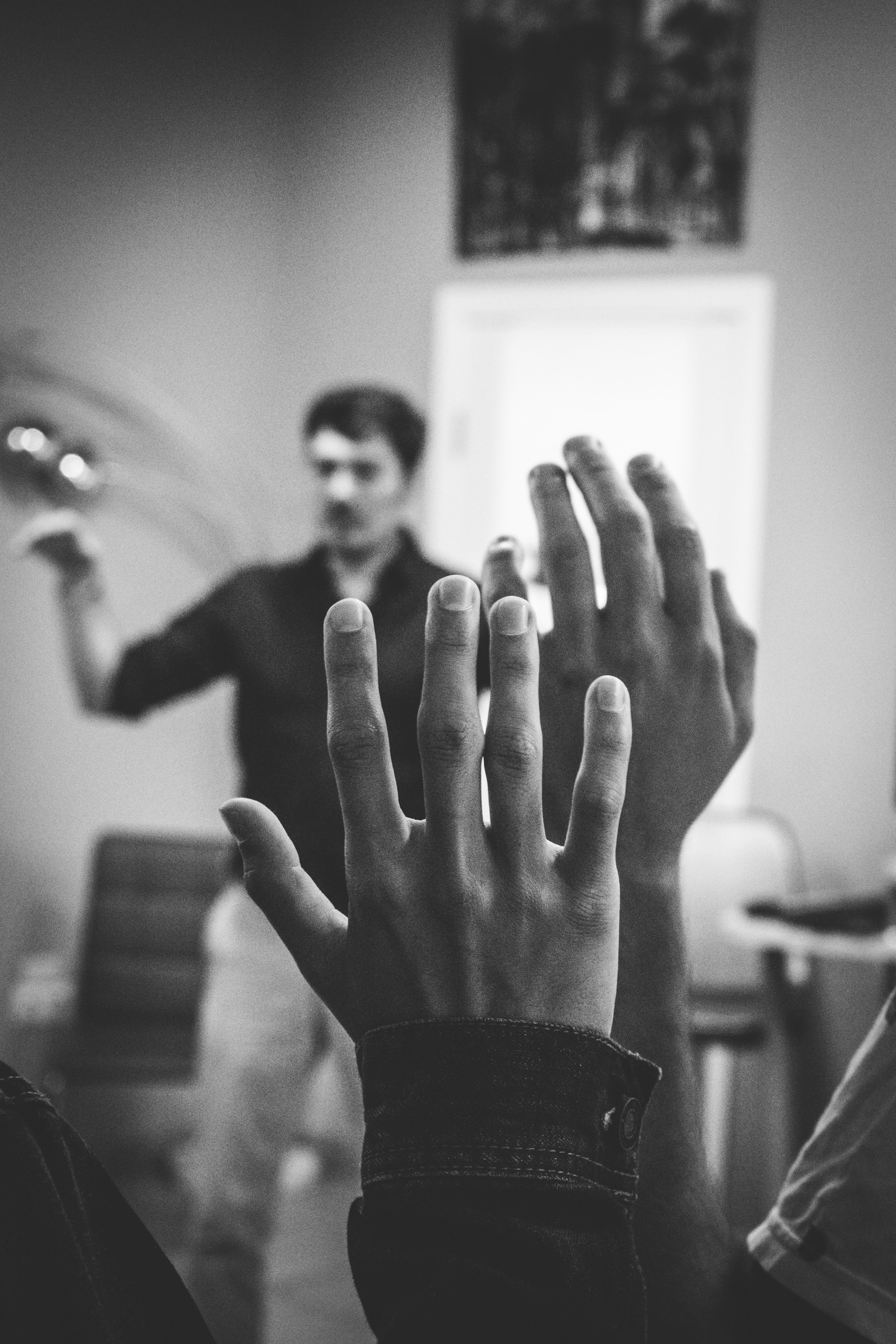 teacher standing in front of student with hands raised